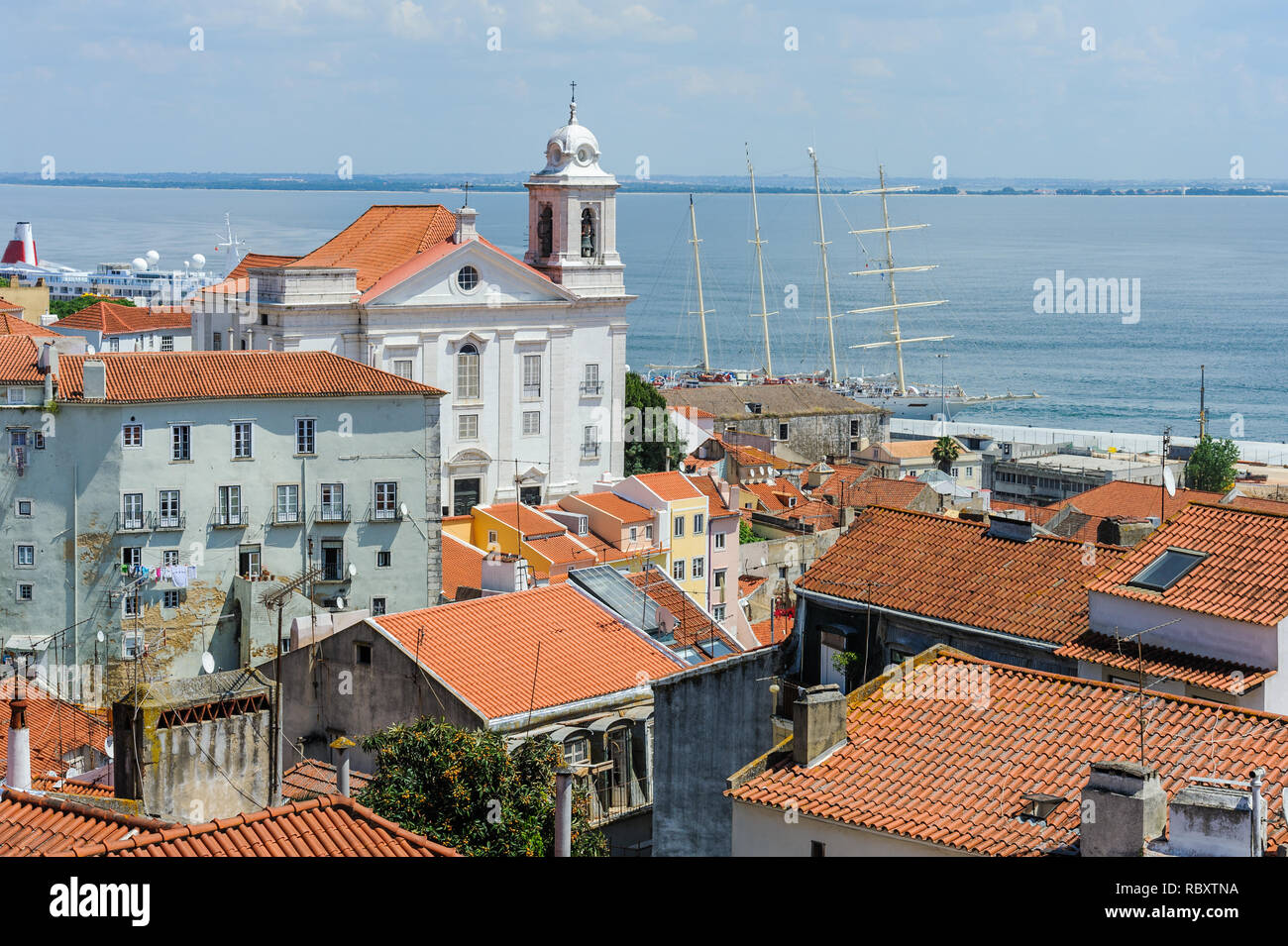 The red roofs of the old houses in the Alfama district in Lisbon, Portugal. Stock Photo