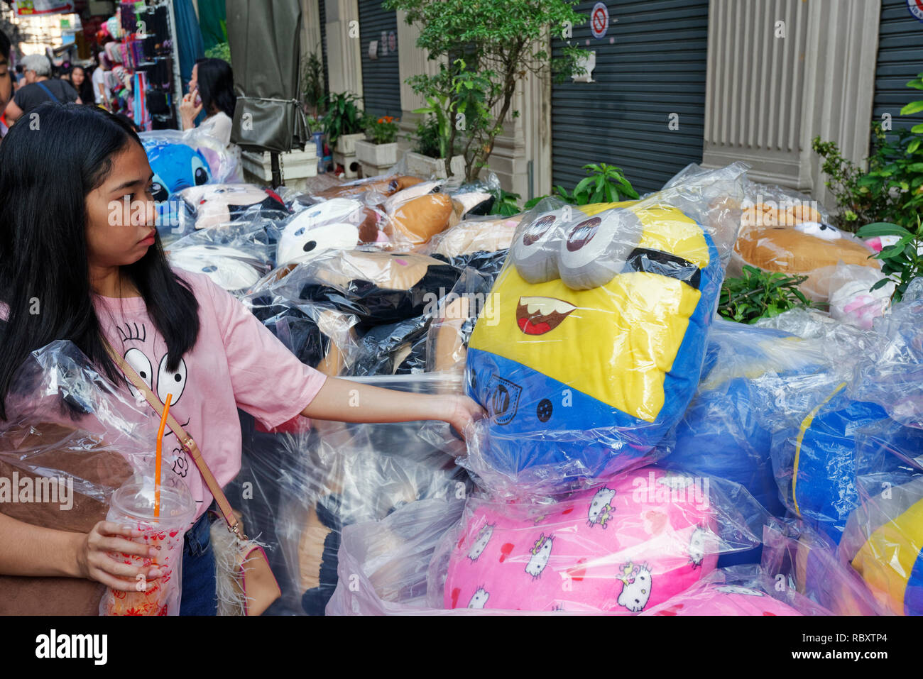 choose a stuffed animal in small street of chinatown, Bangkok, thailandwoman Stock Photo