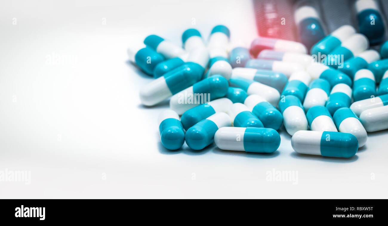 Blue-white antibiotic capsule pills. Pharmaceutical industry. Prescription drug. Medicine for infection. Pharmacy product. Global healthcare. Antimicr Stock Photo