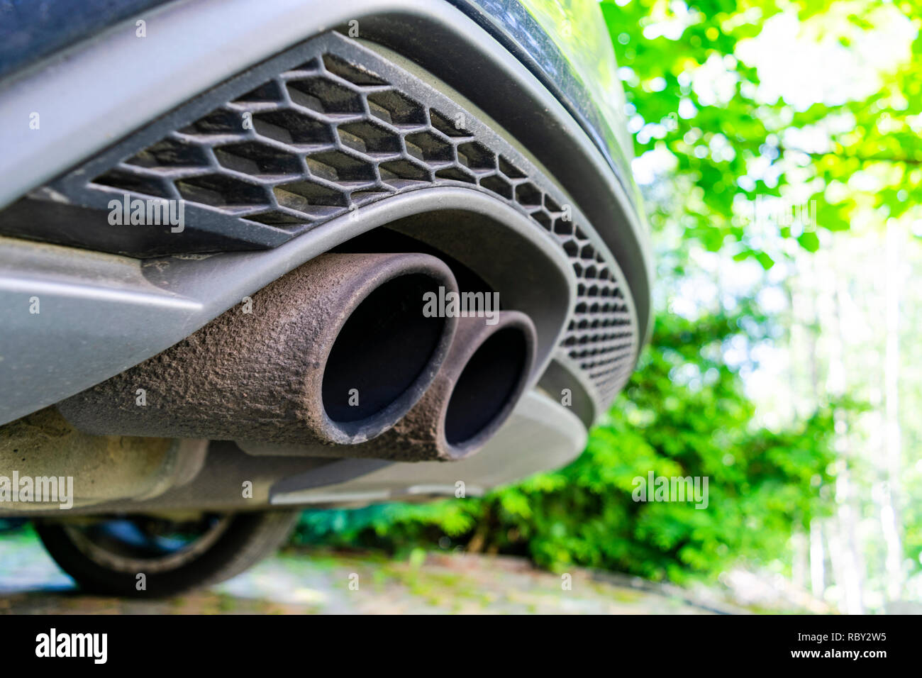 Close up of a car dual exhaust pipe. Double exhaust pipes of a modern