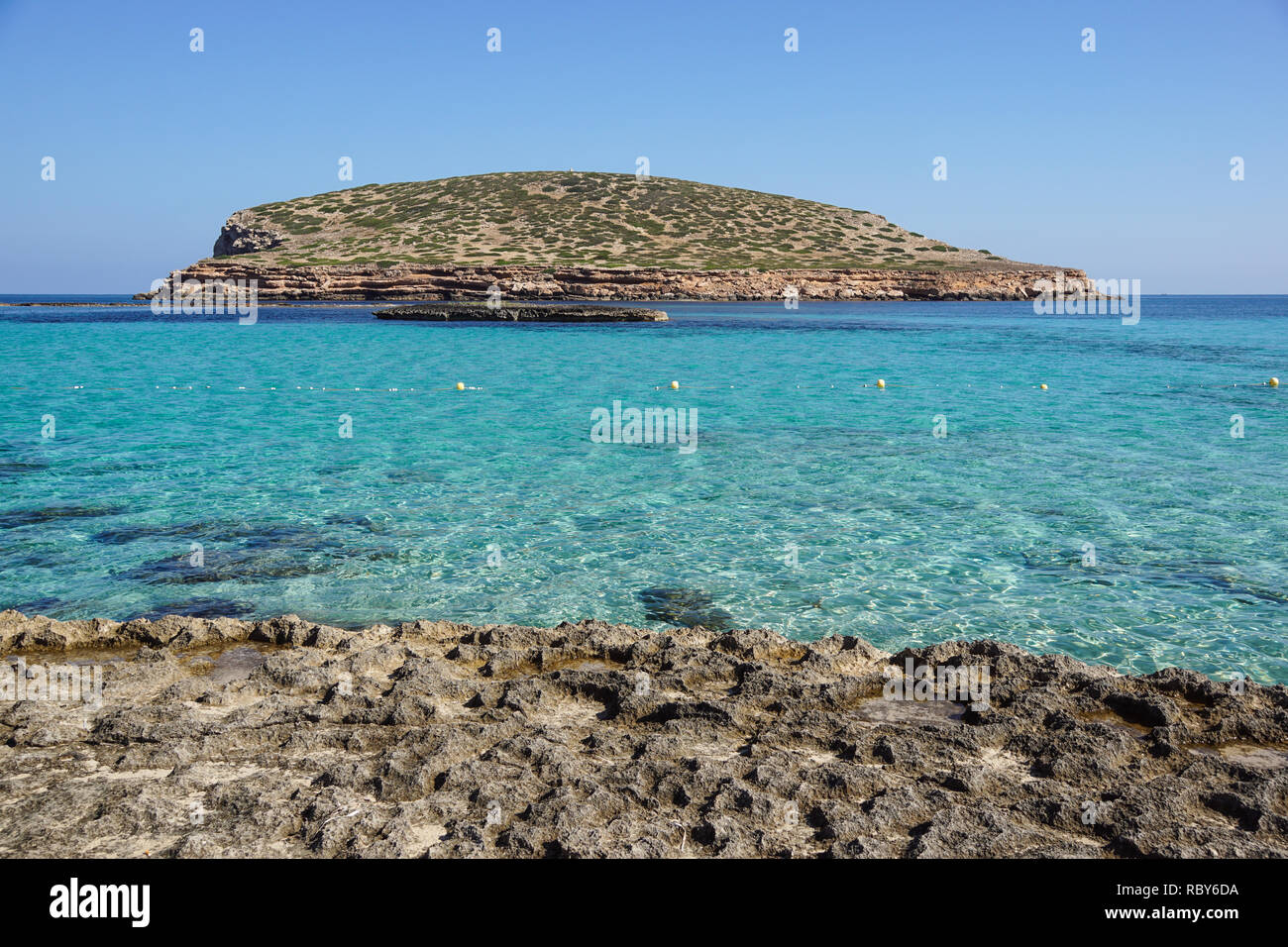 Beautiful sandy Cala Comte beach with azure blue sea water, Ibiza island, Spain Stock Photo
