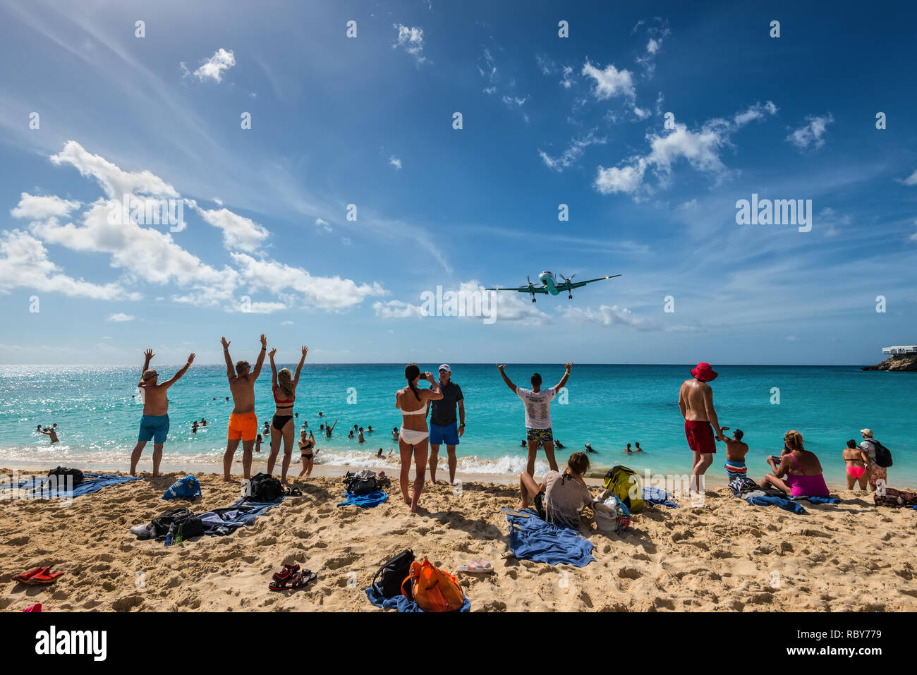 Maho beach, Saint Martin - December 17, 2018: A commercial jet approaches Princess Juliana airport above onlooking spectators. The short runway gives  Stock Photo