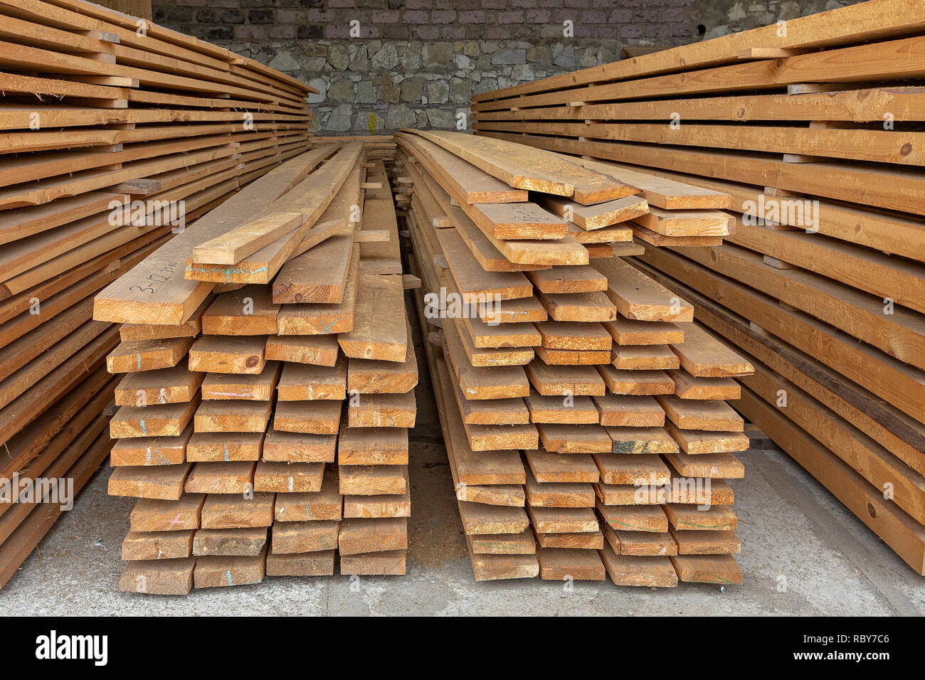 Stacked lumber ready to be sent to customers. Stock Photo