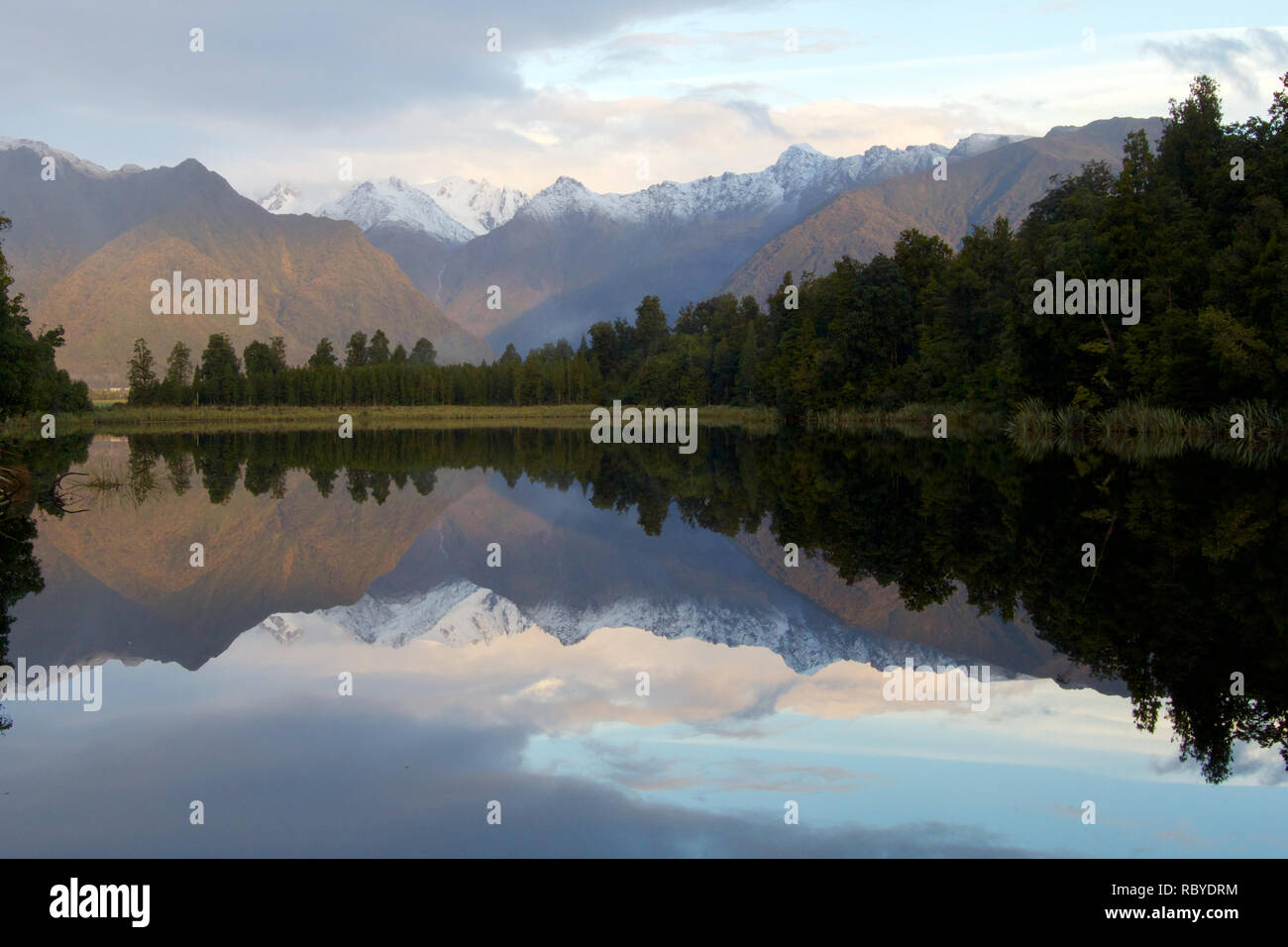 Reflections of Mount Cook and Mount Tasmin in lake Matheson  during an autumn sunset. Clear signs of changing season Stock Photo