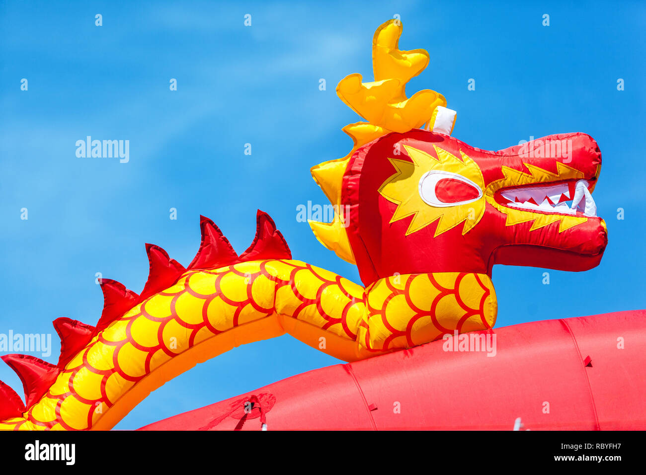 Inflatable china dragon against blue sky Stock Photo