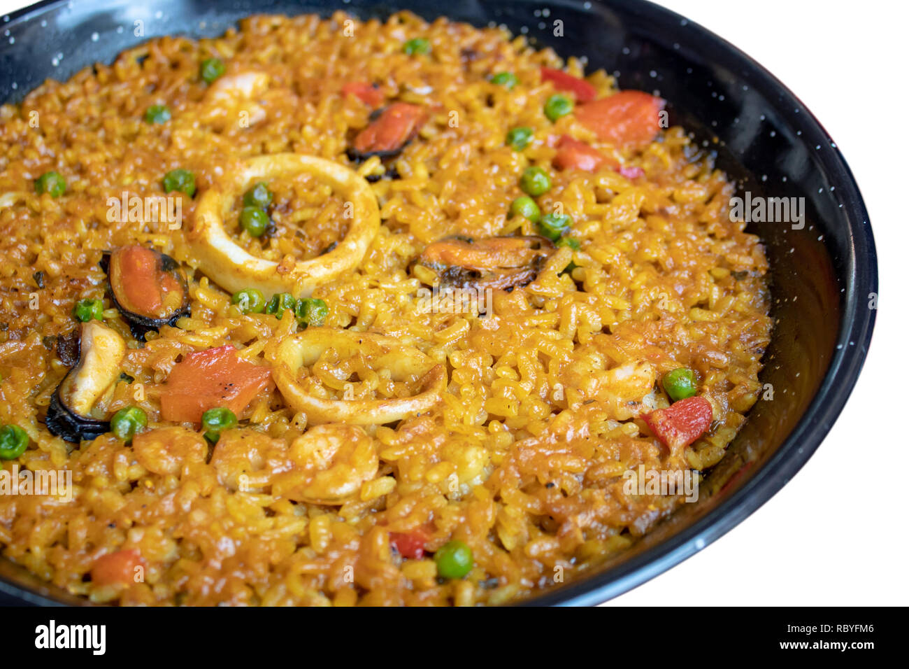 Fresh Spanish paella with rice and seafood in frying pan closeup Stock Photo