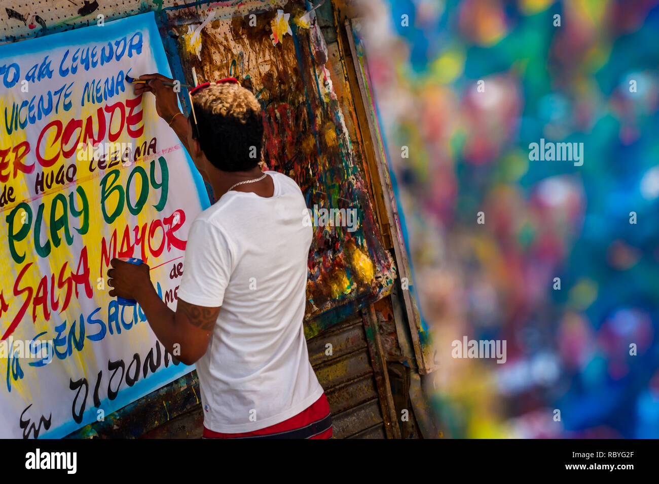 A Colombian sign painter writes with a brush while working on music ...