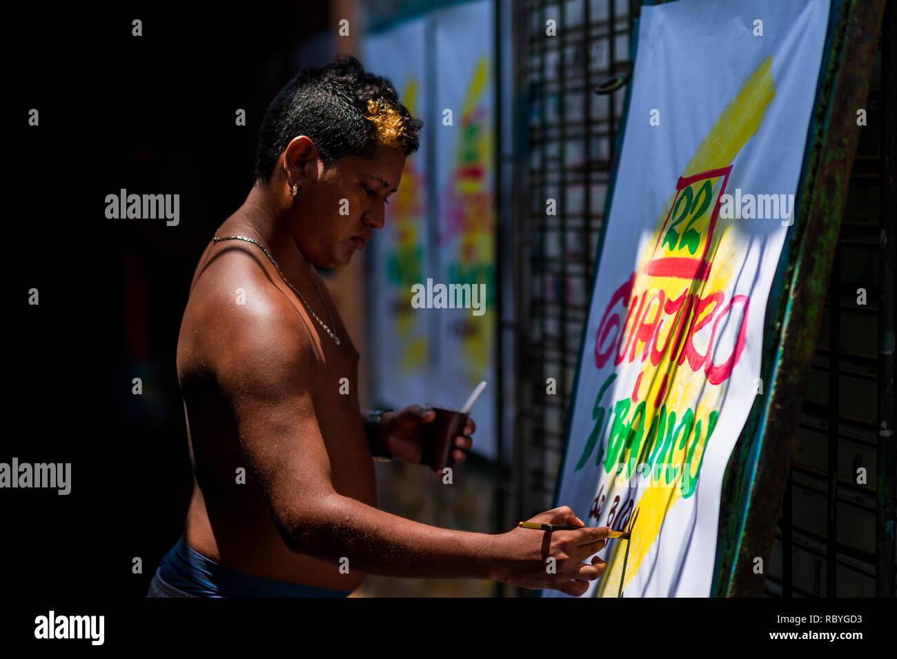 A Colombian sign painter writes with a brush while working on music ...