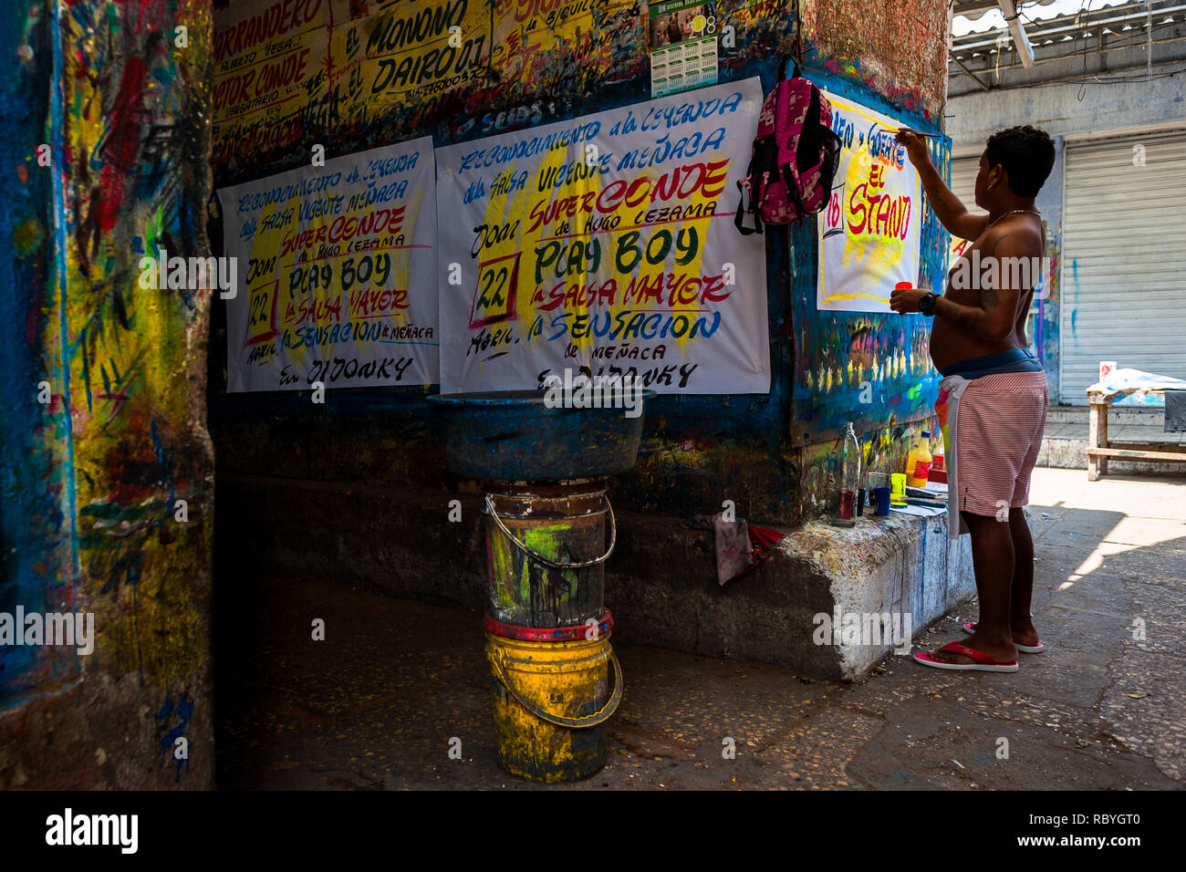 A Colombian sign painter writes with a brush while working on music ...