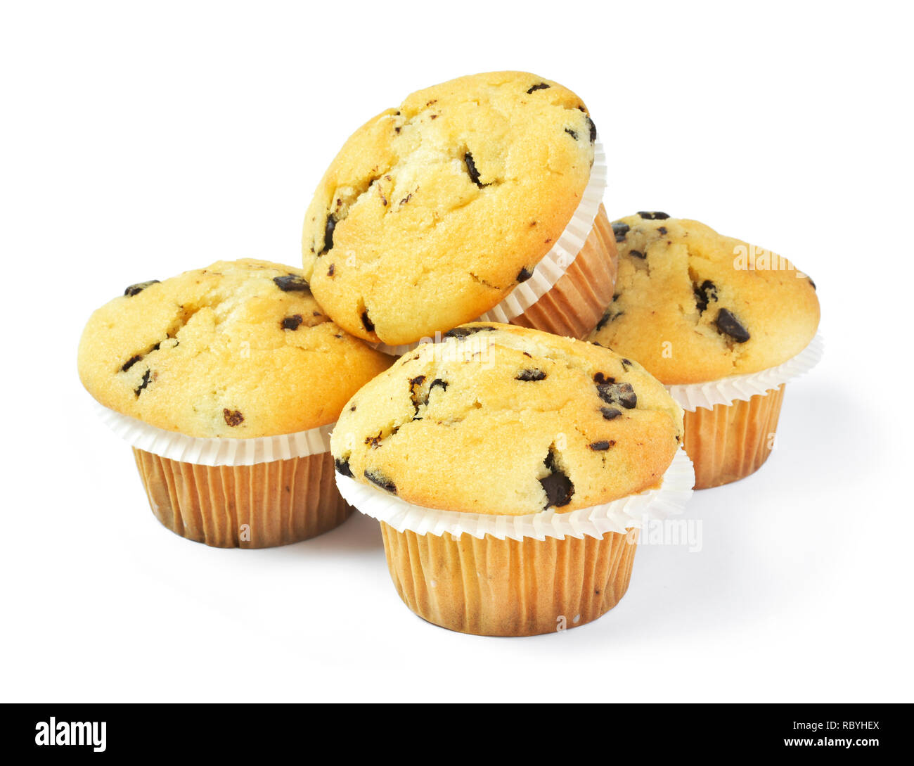 Delicious vanilla muffins with chocolate, isolated on white background. Muffins with paper, sweet food or unhealthy eating theme. Stock Photo