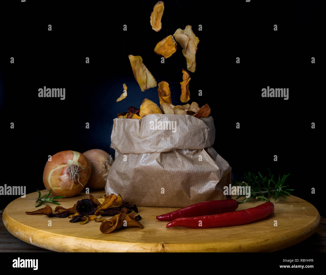 healthy chips made from vegetables or vegetable chips falling in a paper  bag on a wooden table with onion garlic red pepper and oregano Stock Photo  - Alamy, image size:1300x1096