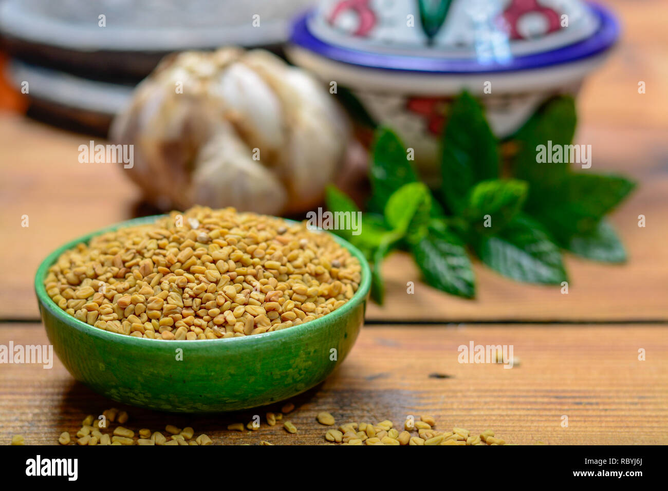 Bowl with fenugreek seeds closeup, used for cooking and traditinal