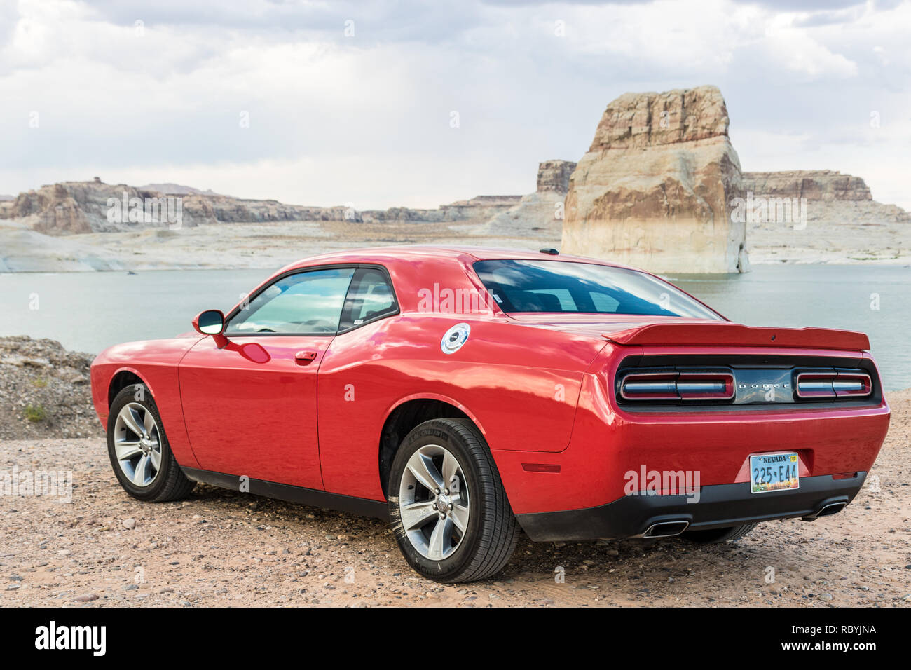 PAGE,  ARIZONA, USA - CIRCA AUGUST 2018:  a red Dodge Challenger parked on the beach of the Powell Lake Stock Photo