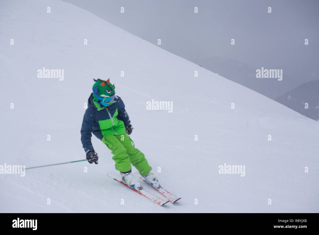 Boy skiing downhill in french ski resort Stock Photo Alamy