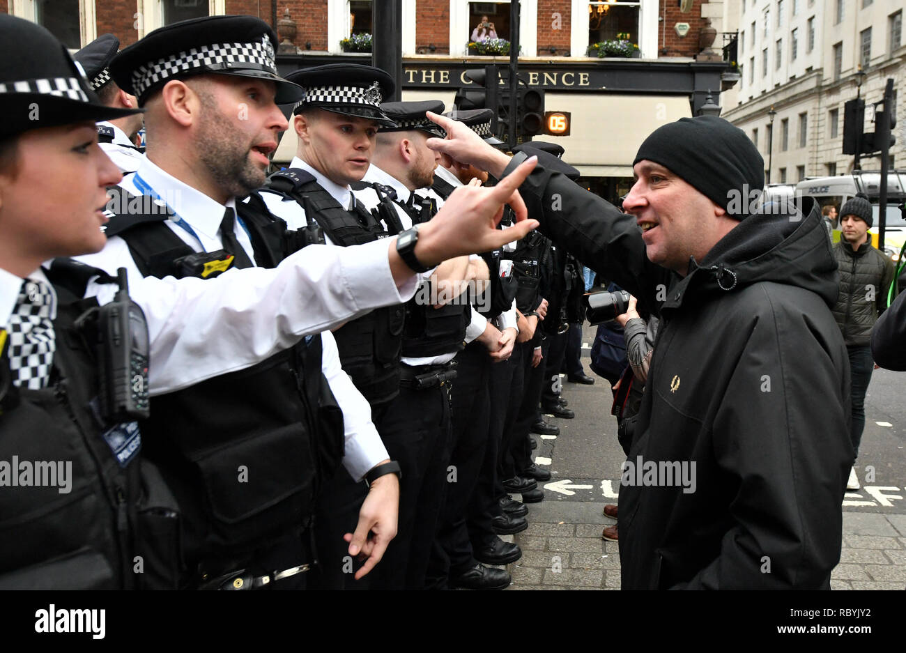 A demonstrator argues with police officers as Pro-Brexit demonstrators attempt to get into Trafalgar Square, London, where a rally organised by the People's Assembly Against Austerity are gathered. Stock Photo