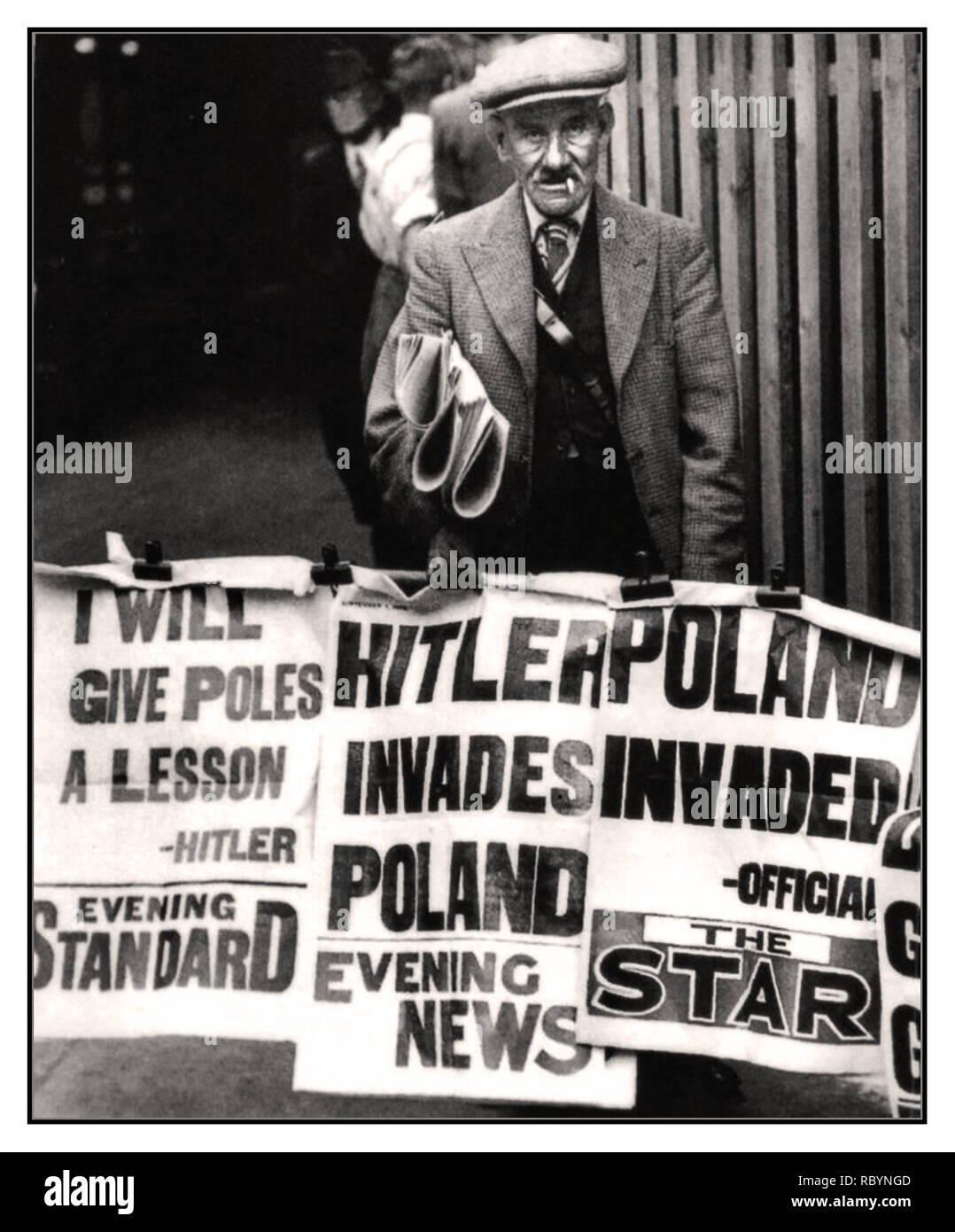 HITLER POLAND INVASION VINTAGE NEWSPAPER VENDOR  SEPTEMBER 1939 UK NEWSPAPERS HITLER INVADES POLAND  British newspaper seller and posters with news headlines that the Nazis have invaded and occupied Poland which started World War II.      Location: London, UK Date: September 1, 1939 Stock Photo