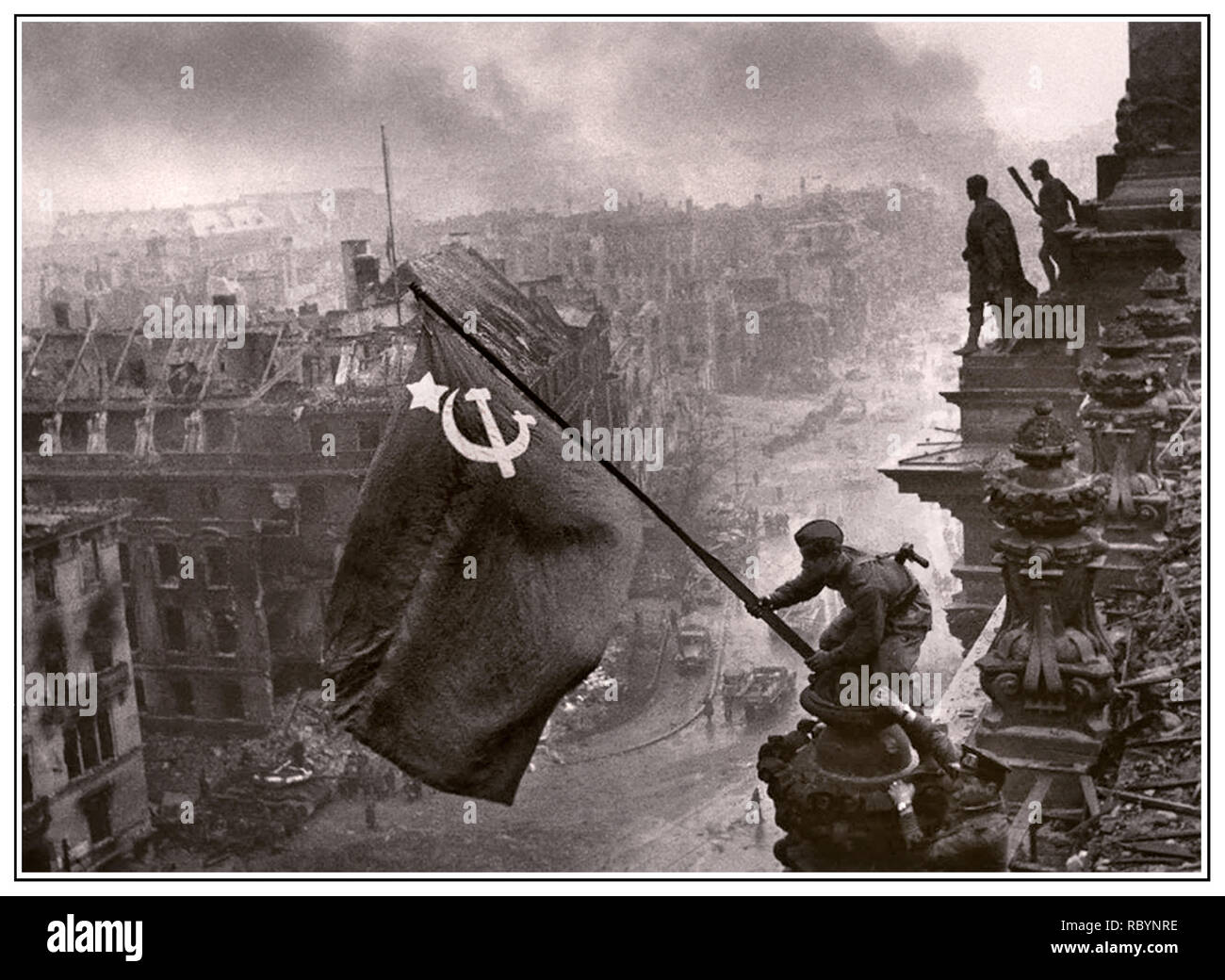 RUSSIAN ARMY SOVIET FLAG OVER NAZI BERLIN REICHSTAG World War II Germany. Iconic image of raising a Russian Soviet flag over the Reichstag, an historic World War II photograph, taken during the Battle of Berlin on 2 May 1945. It shows Meliton Kantaria and Mikhail Yegorov raising the Hammer and Sickle flag over the Berlin Reichstag with Berlin in ruins behind. Germany WW2 Red Army Soviet Soldiers Hammer and Sickle Soviet flag Nazi Headquarters Reichstag, Berlin Germany 1945 Stock Photo