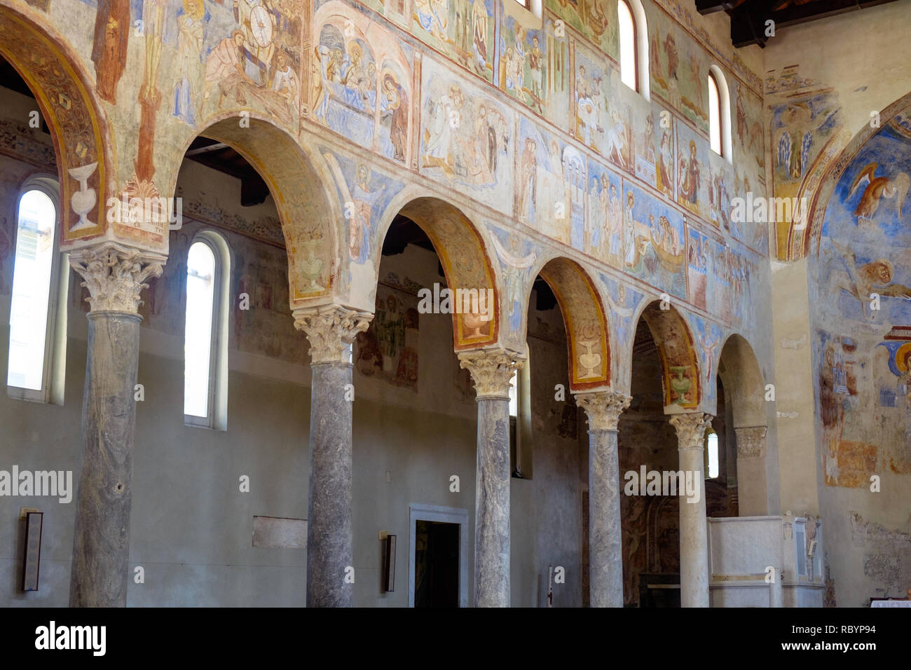 The church 'Sant'Angelo in Formis' is of particular historical value and was built in the 11th century. Here, you see columns and impressive frescos. Stock Photo