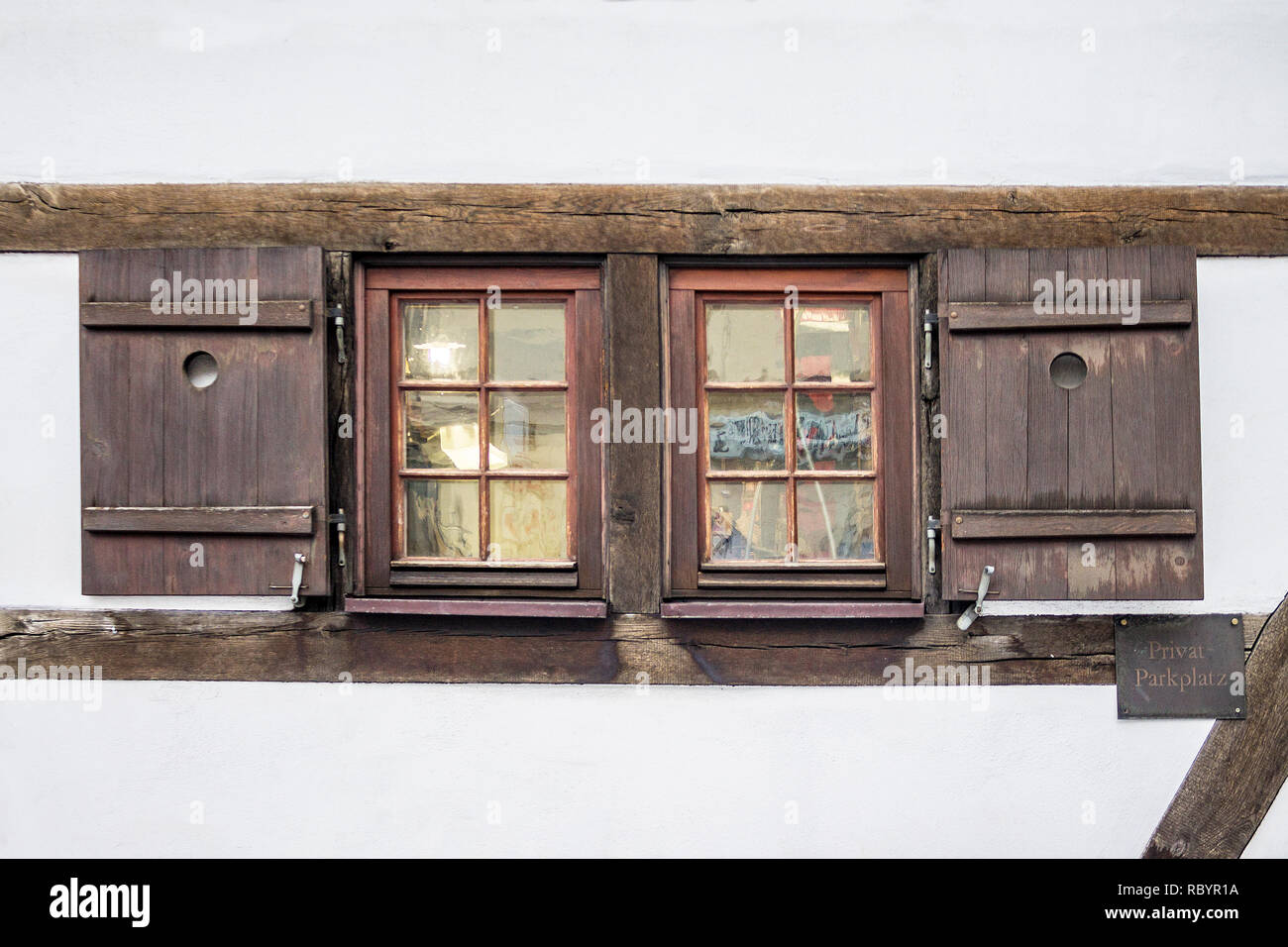Old ancient wooden window with blinds or shutters. Scenic original and colorful view of antique windows in old city Sindelfingen, Germany. Isolated on Stock Photo