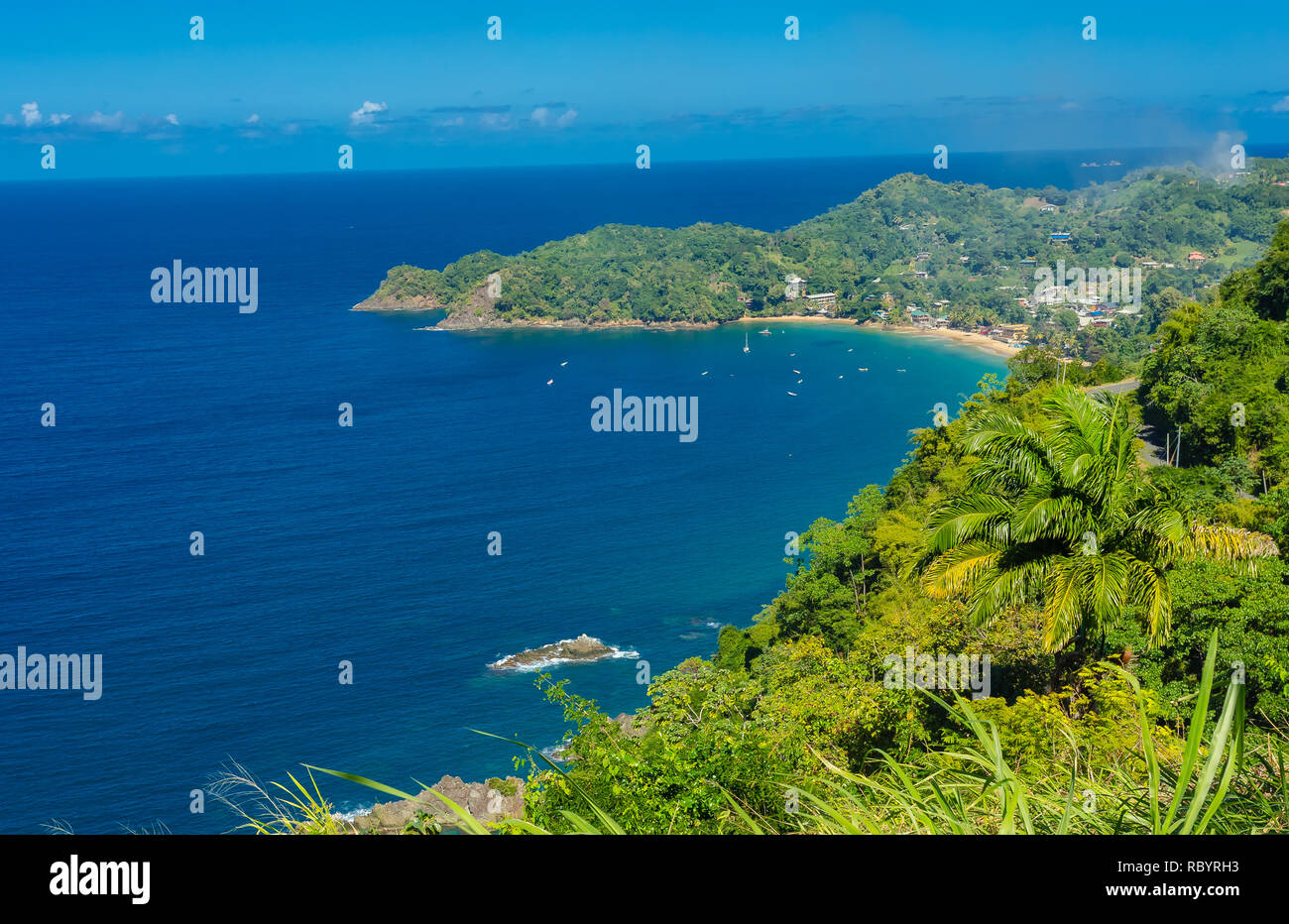 Castara is a small fishing village on the tropical island of Tobago in the Caribbean.  Often called the original Robinson Crusoe island. Deep blue sky Stock Photo