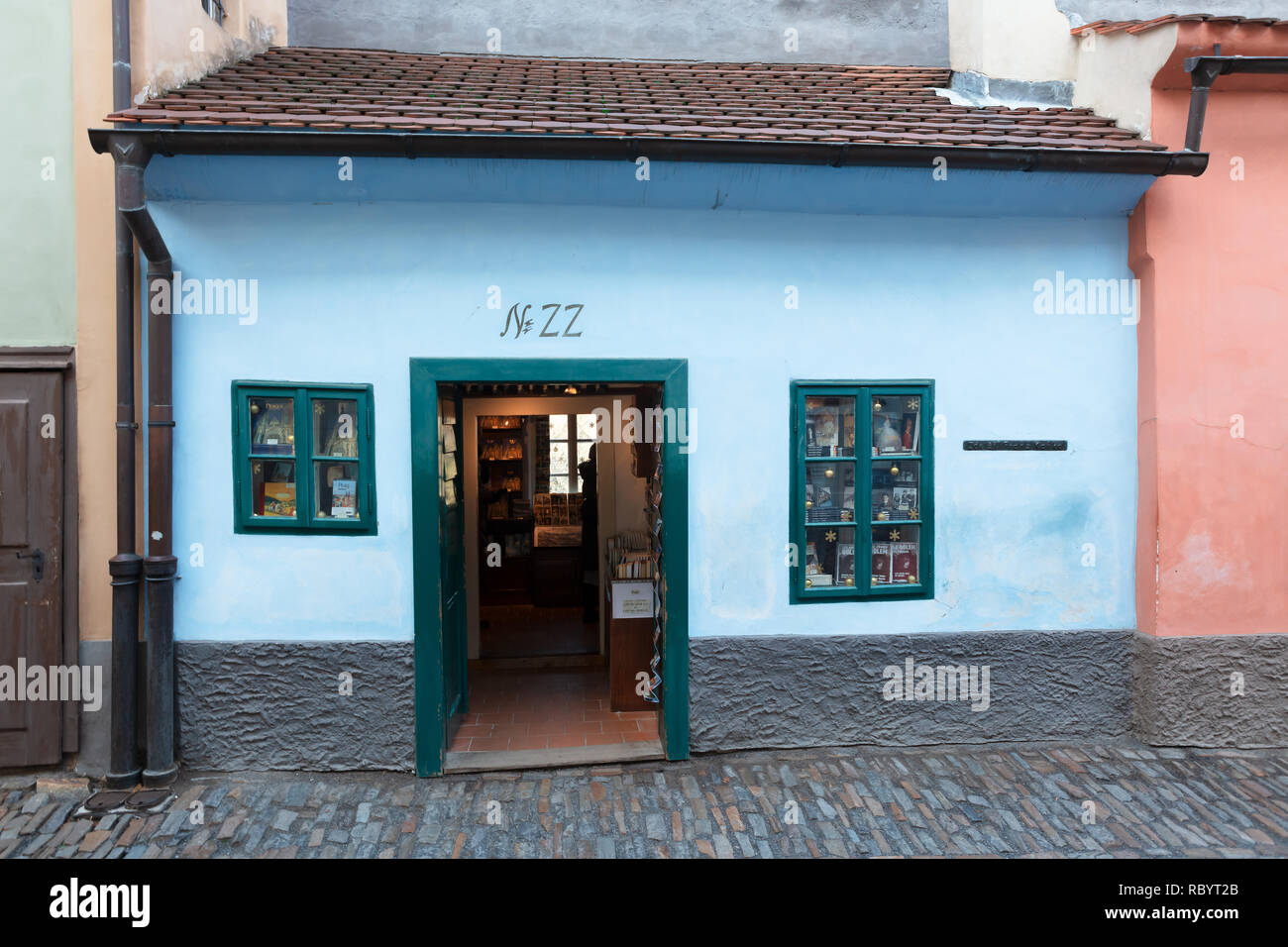Franz Kafka lived and worked in this tiny brightly painted house on Golden Lane built into the Prague Castle's fortification in 16 century. Stock Photo