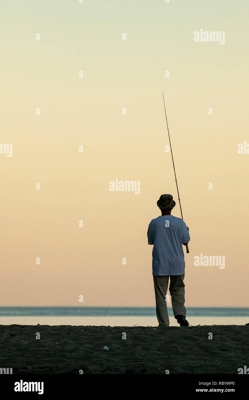 Silhouette man fishing on beach hi-res stock photography and images - Alamy