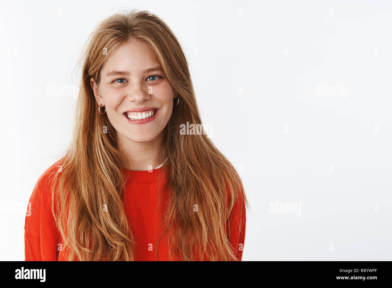 Positive Teenage Girl With Long Natural Hair And Freckles Smiling