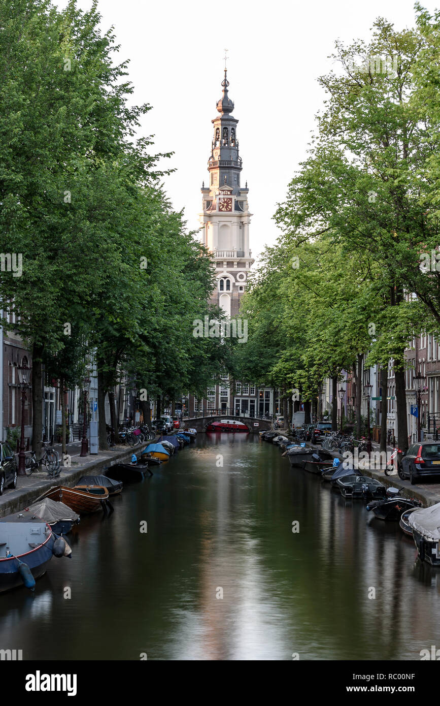 A view along an Amsterdam canal, towards the Zuiderkerk church, built in 1611 & once painted by Monet. Stock Photo