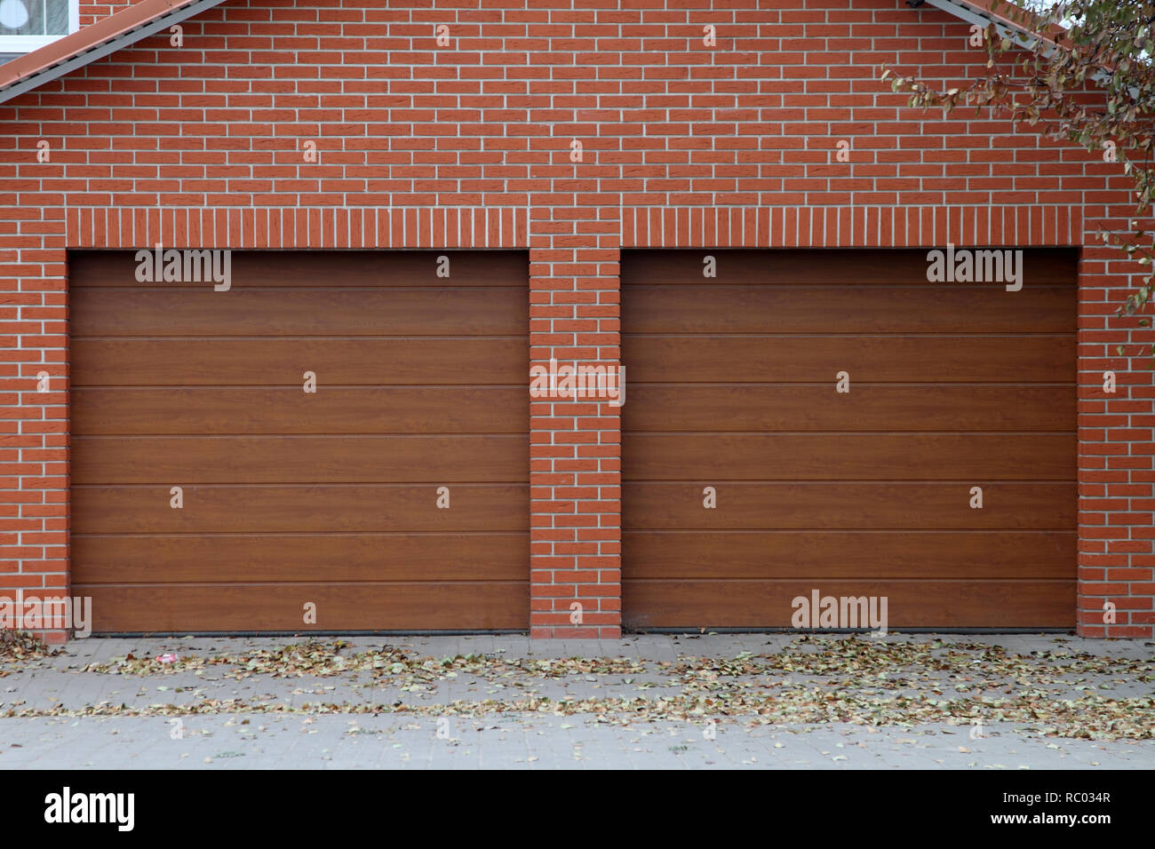 Brick garage for two cars with automatic gates. Stock Photo