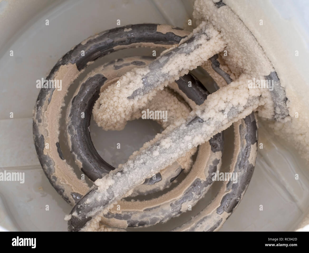 Limescale in kettle. A white, chalky residue from deposit of calcium carbonate. Hard water problem. Stock Photo