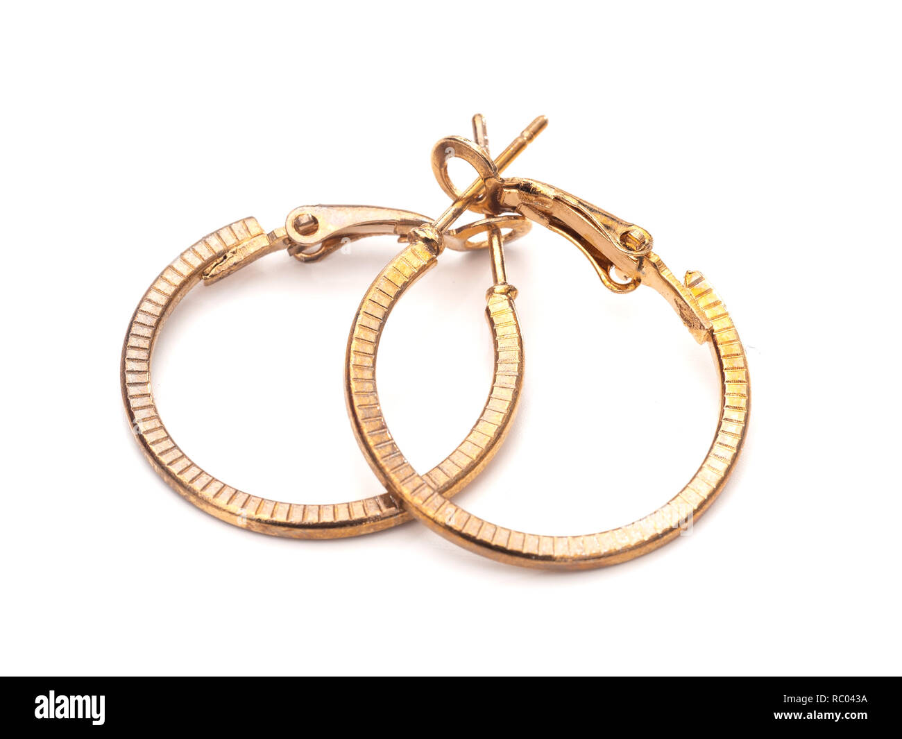 Vintage gold colour hoop earrings, pair, on white background. Stock Photo
