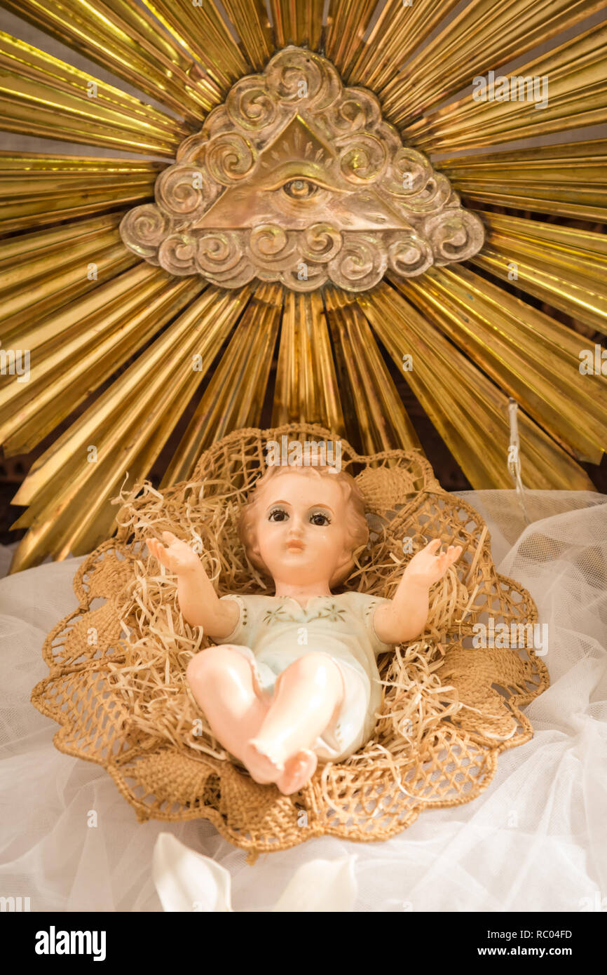 Christmas scene Baby Jesus vintage figurine in his crib in an Italian church during Christmas time Stock Photo