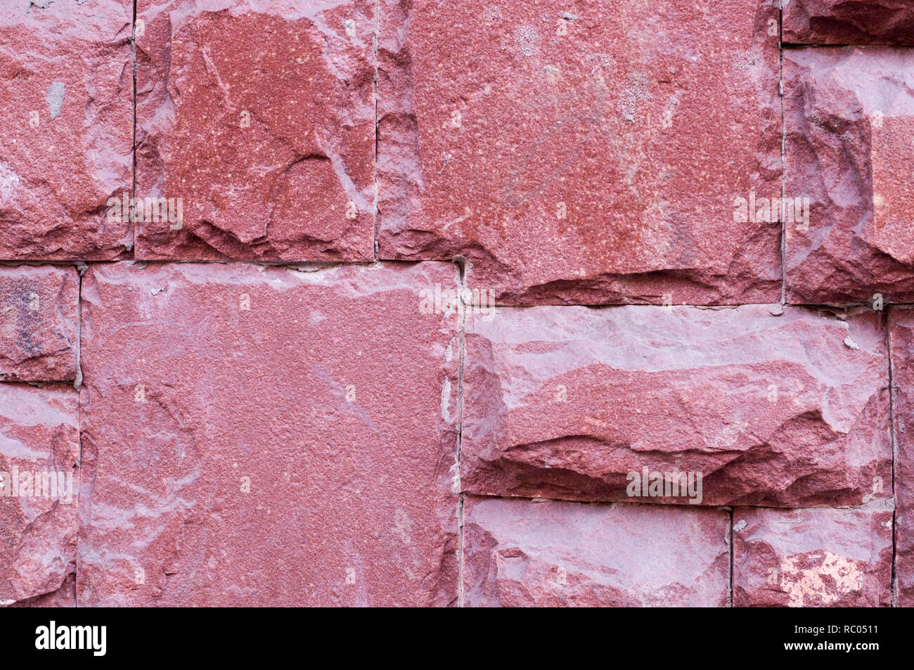 modern red stone tiled wall background. texture, geological. Stock Photo