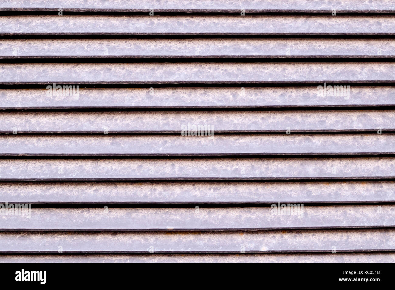 horizontal stripes of dusty metal jalousie exterior. background, texture. Stock Photo