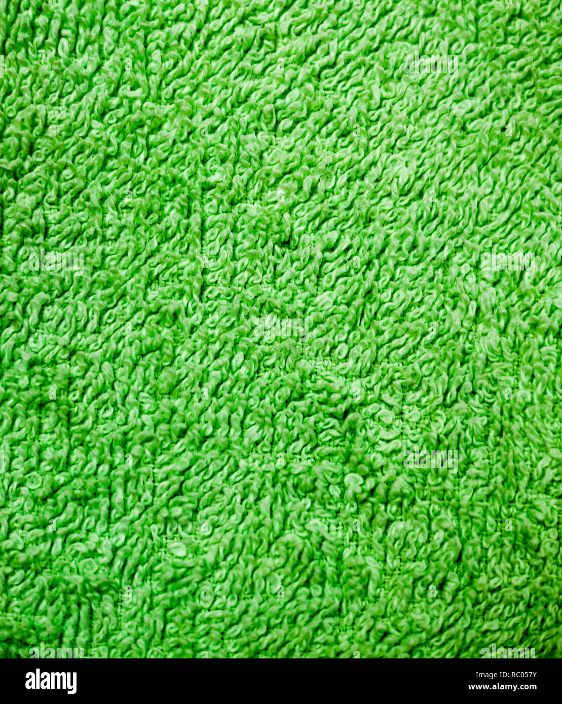 green fabric terry cloth towel texture. background, bedroom Stock Photo