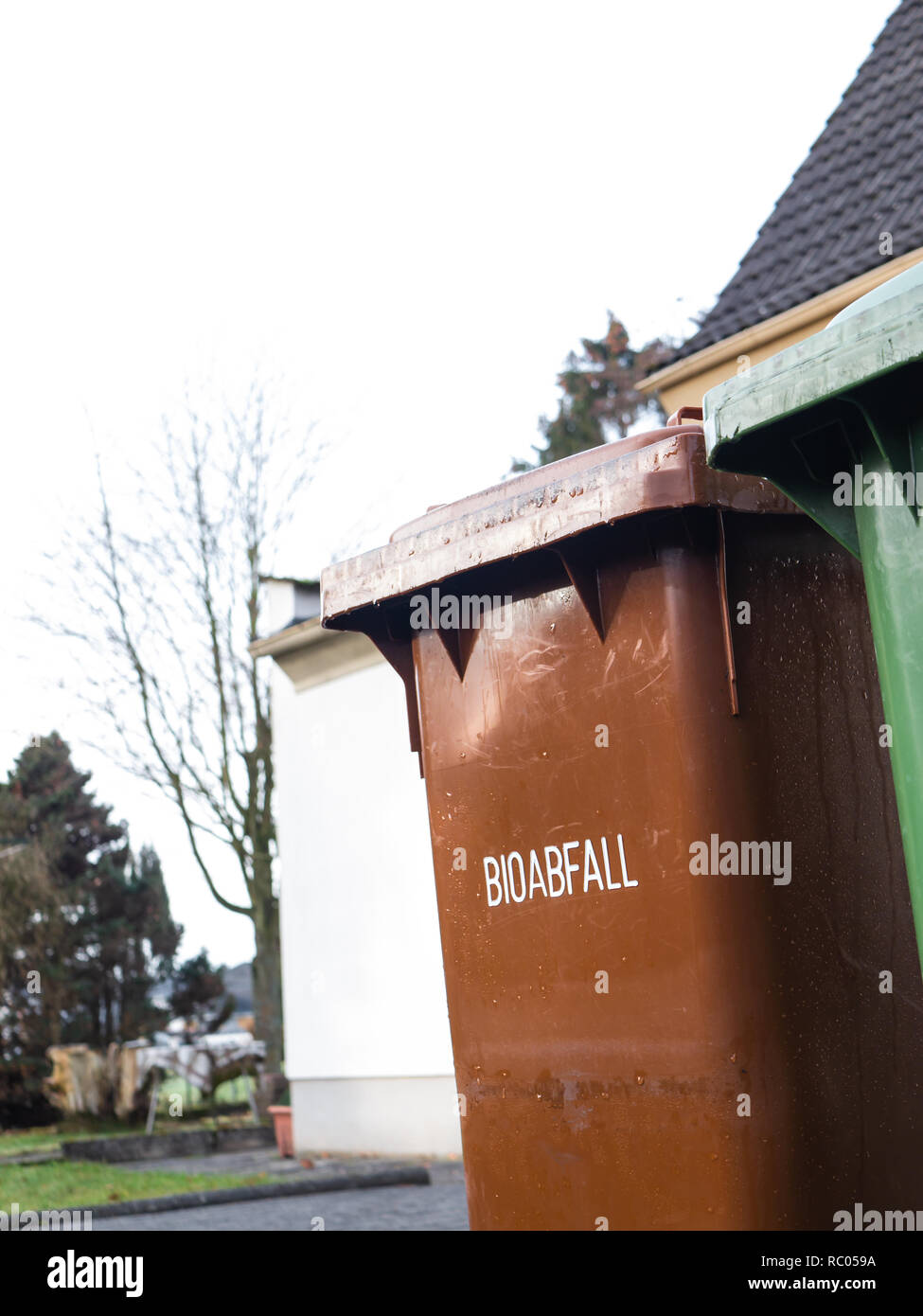 Brown German Garbage Can for biodegradable Waste, Text saying 'Biodegradable Waste' Stock Photo