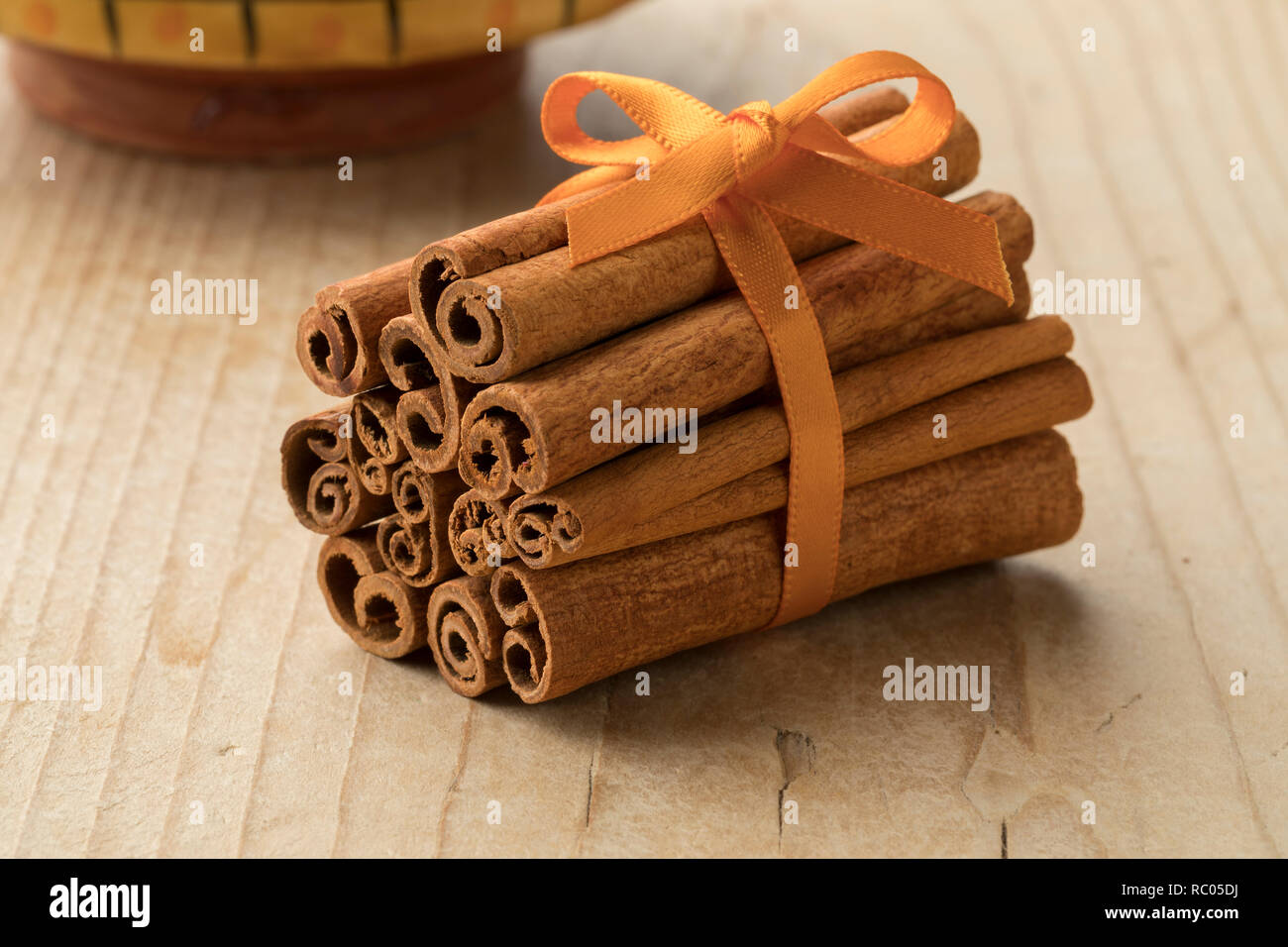 Bunch of cassia cinnamon sticks with an orange ribbon Stock Photo