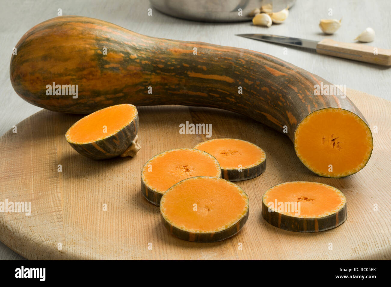 Fresh raw Long neck pumpkin and slices ready to cook Stock Photo