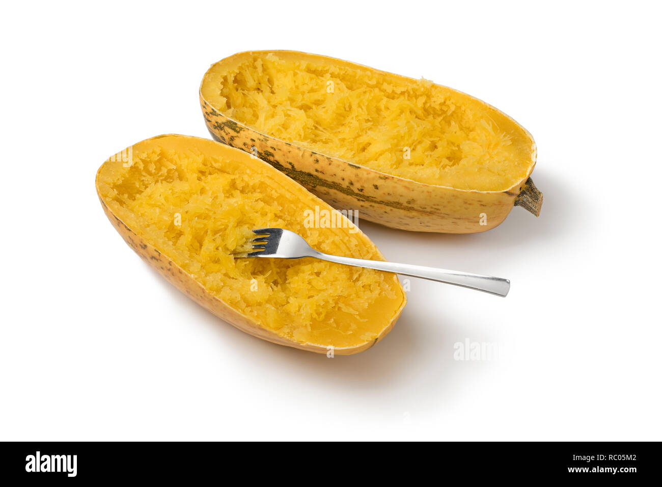 Two halved cooked spaghetti squashes isolated on white background Stock Photo