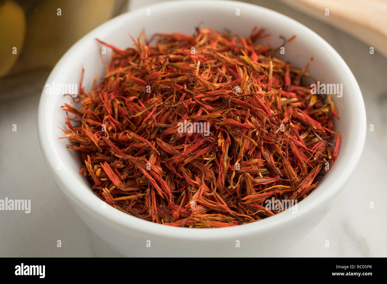 Bowl with dried orange saffron threads close up Stock Photo