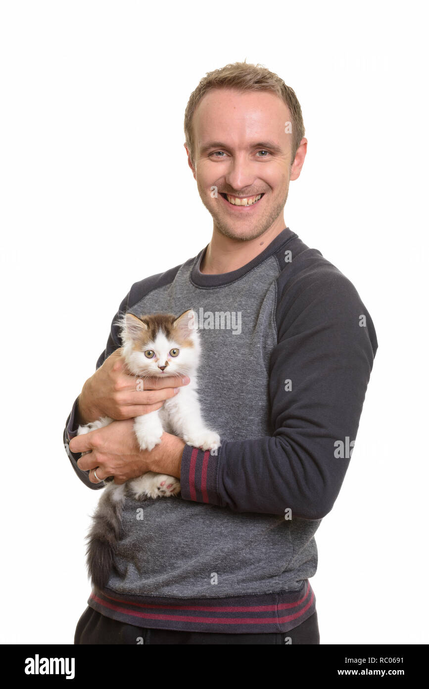 Happy handsome Caucasian man holding cute kitten Stock Photo