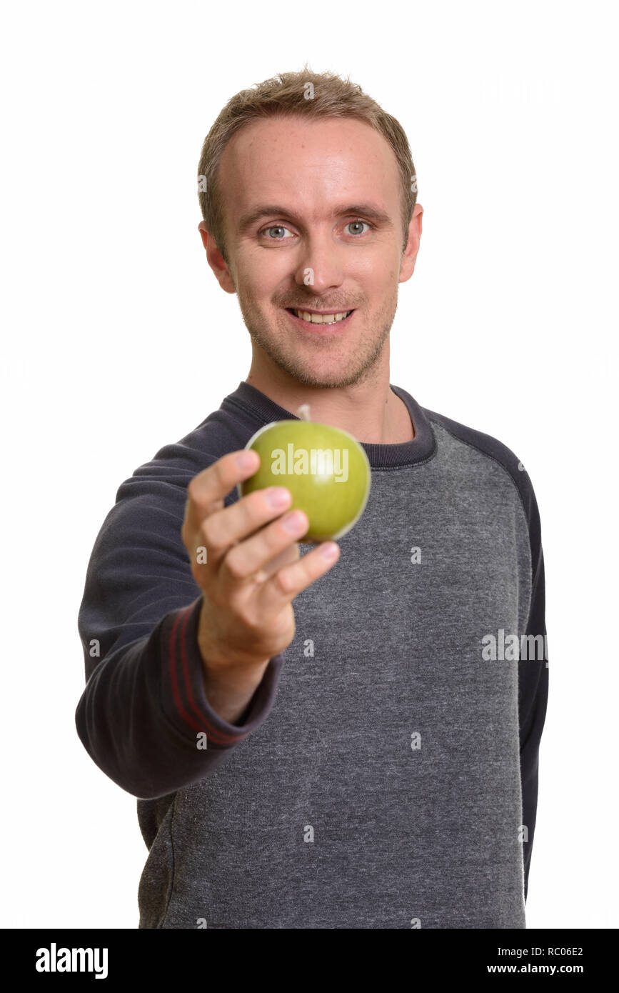 Happy handsome Caucasian man giving green apple Stock Photo - Alamy