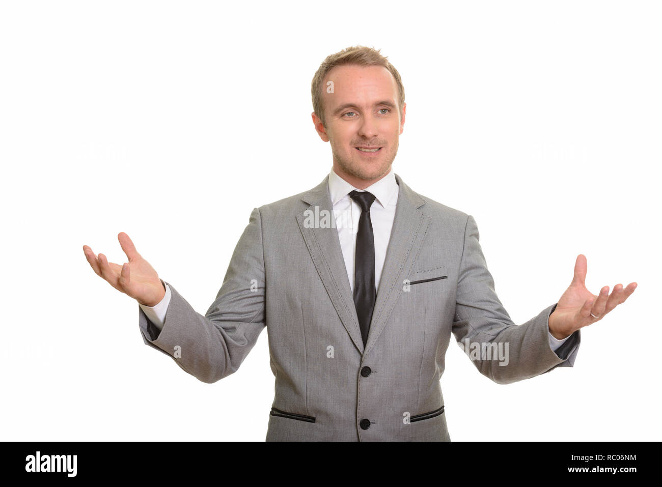 Handsome Caucasian businessman giving speech isolated against white background Stock Photo