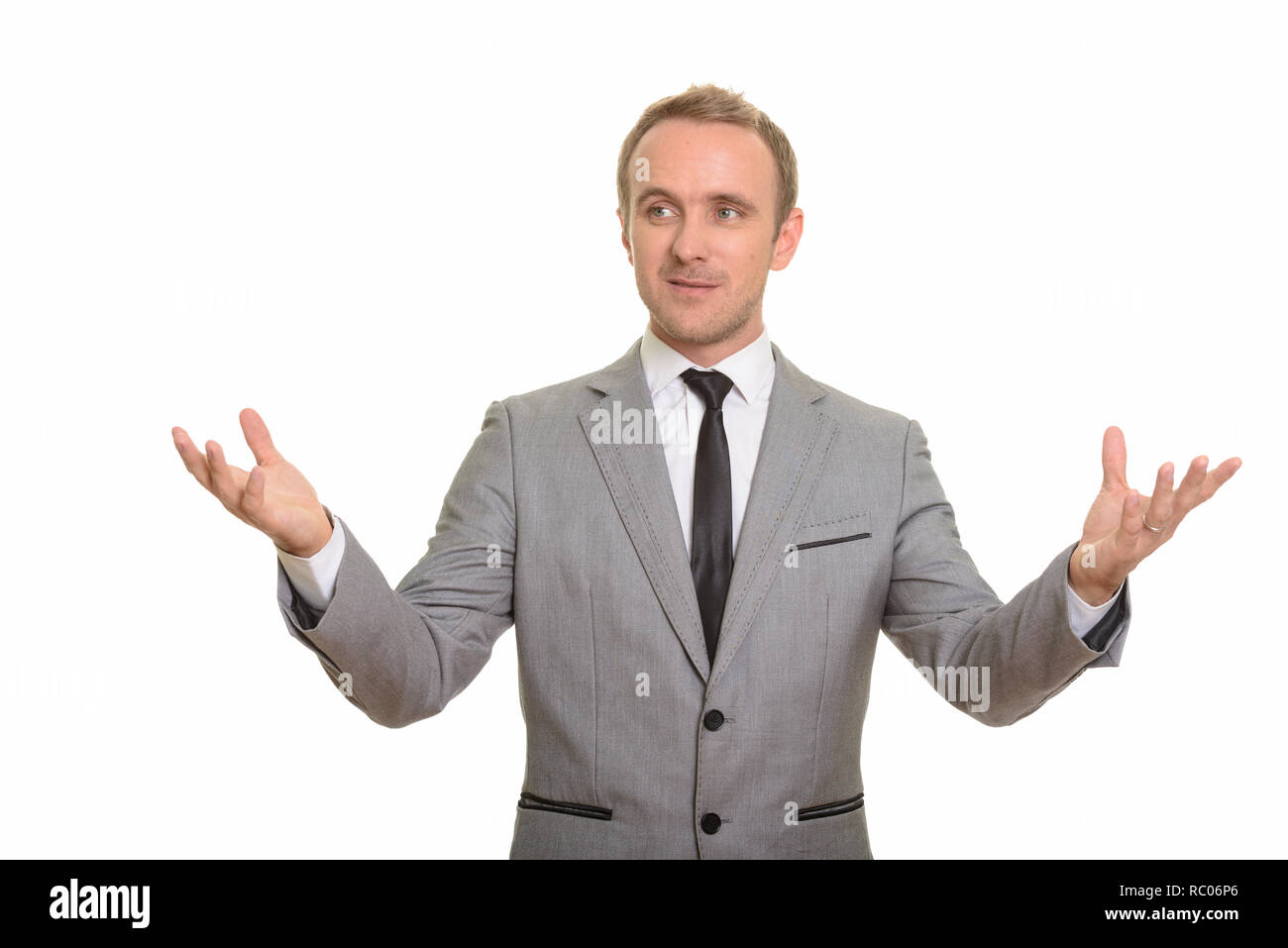 Handsome Caucasian businessman giving speech isolated against white background Stock Photo