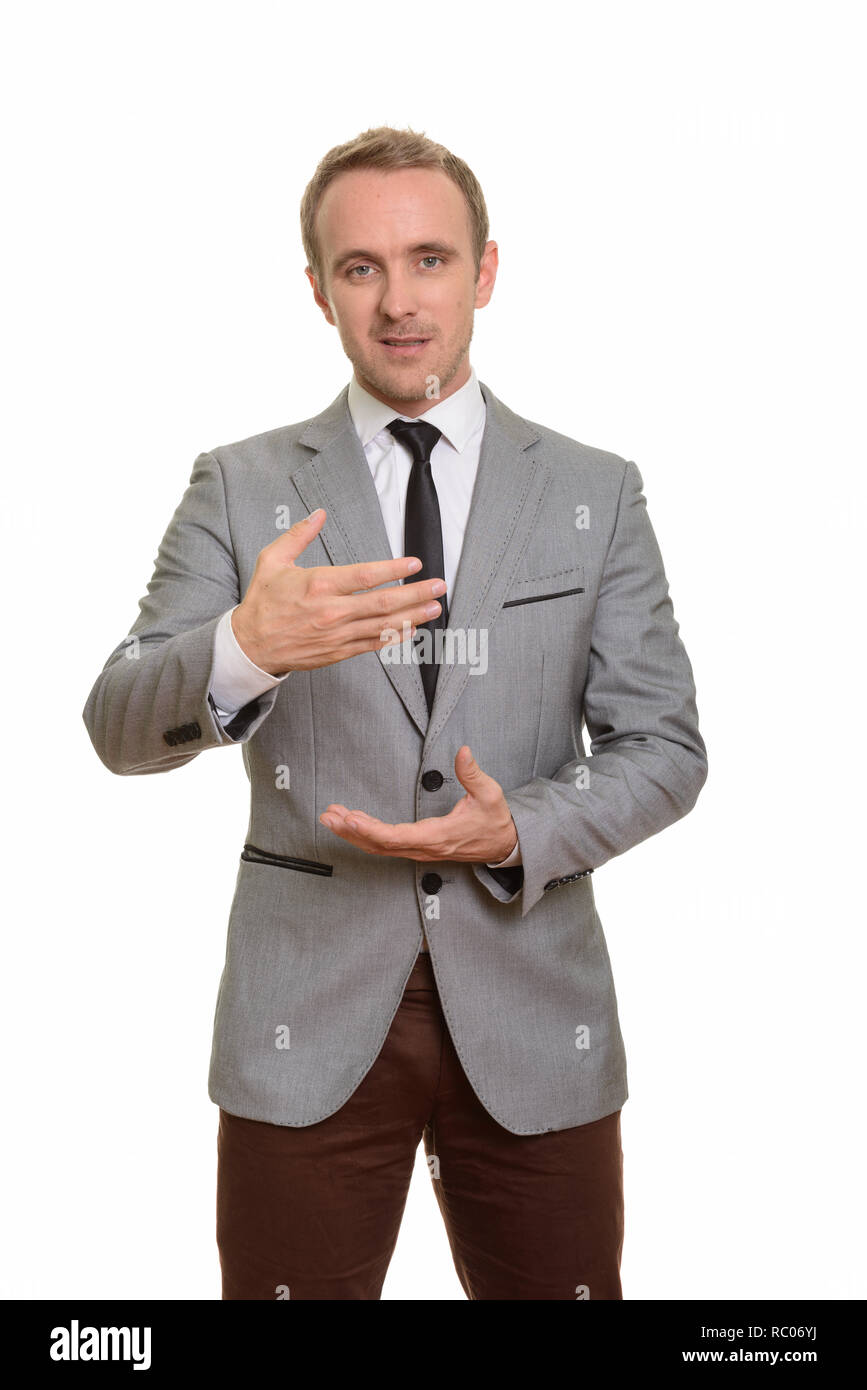 Handsome Caucasian businessman explaining isolated against white background Stock Photo