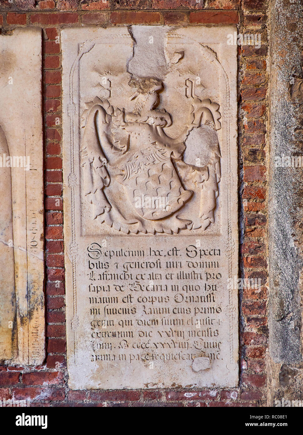 One of the Medieval gravestone on walls of the Ansperto Atrium of the Basilica of Sant'Ambrogio. Milan, Lombardy, Italy. Stock Photo