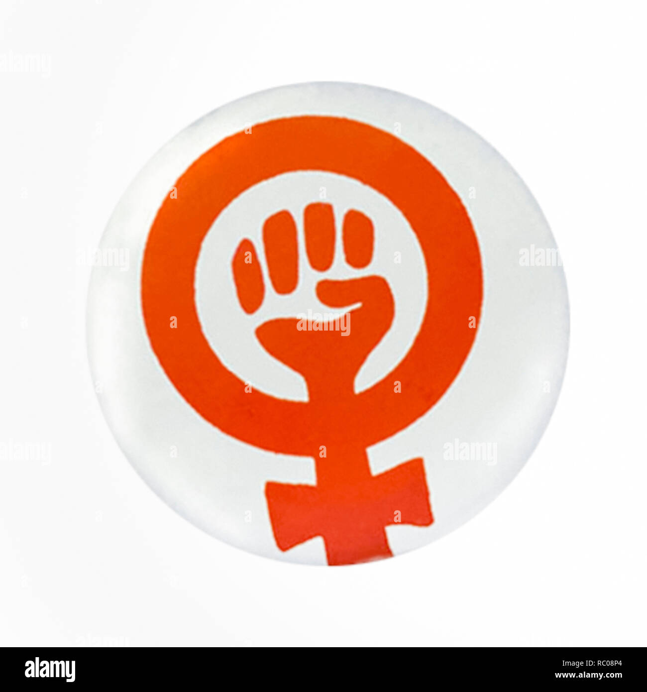 Women's liberation movement (WLM) button badge circa 1970 featuring one of its symbols, a clenched fist inside a Venus sign. See more information below. Stock Photo