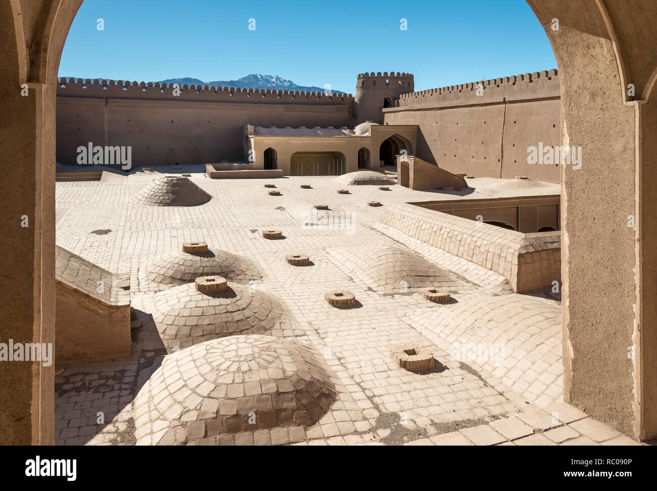 Roof view of an adobe castle Rayen close to the town Kerman under mountain Haraz, Iran Stock Photo
