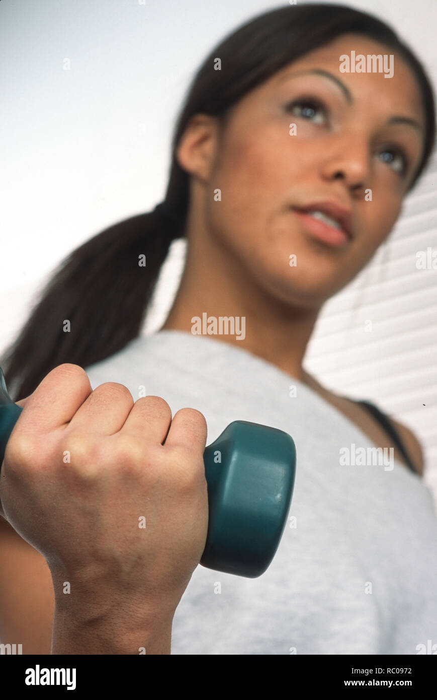 Young female adult lifting weight, USA Stock Photo
