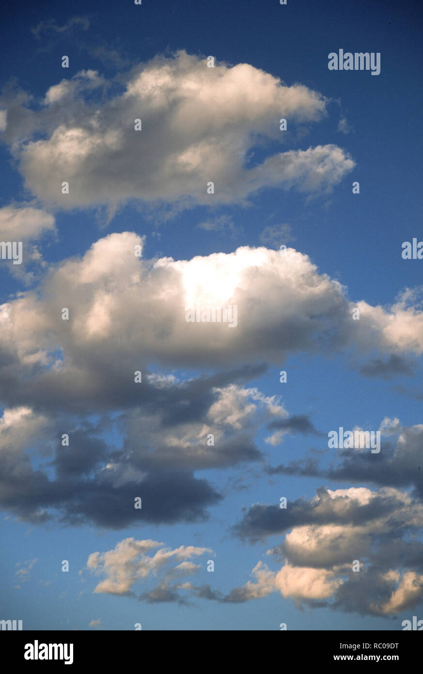 Puffy white clouds in a blue sky Stock Photo